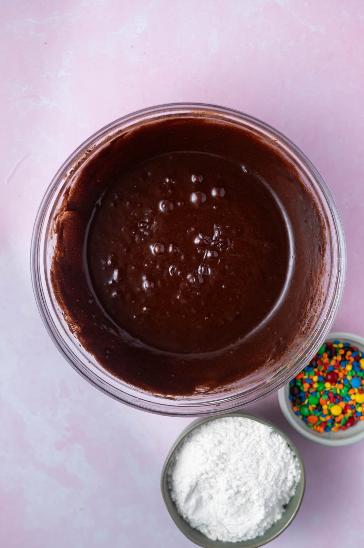 cocoa powder whisked into cookie dough in a bowl
