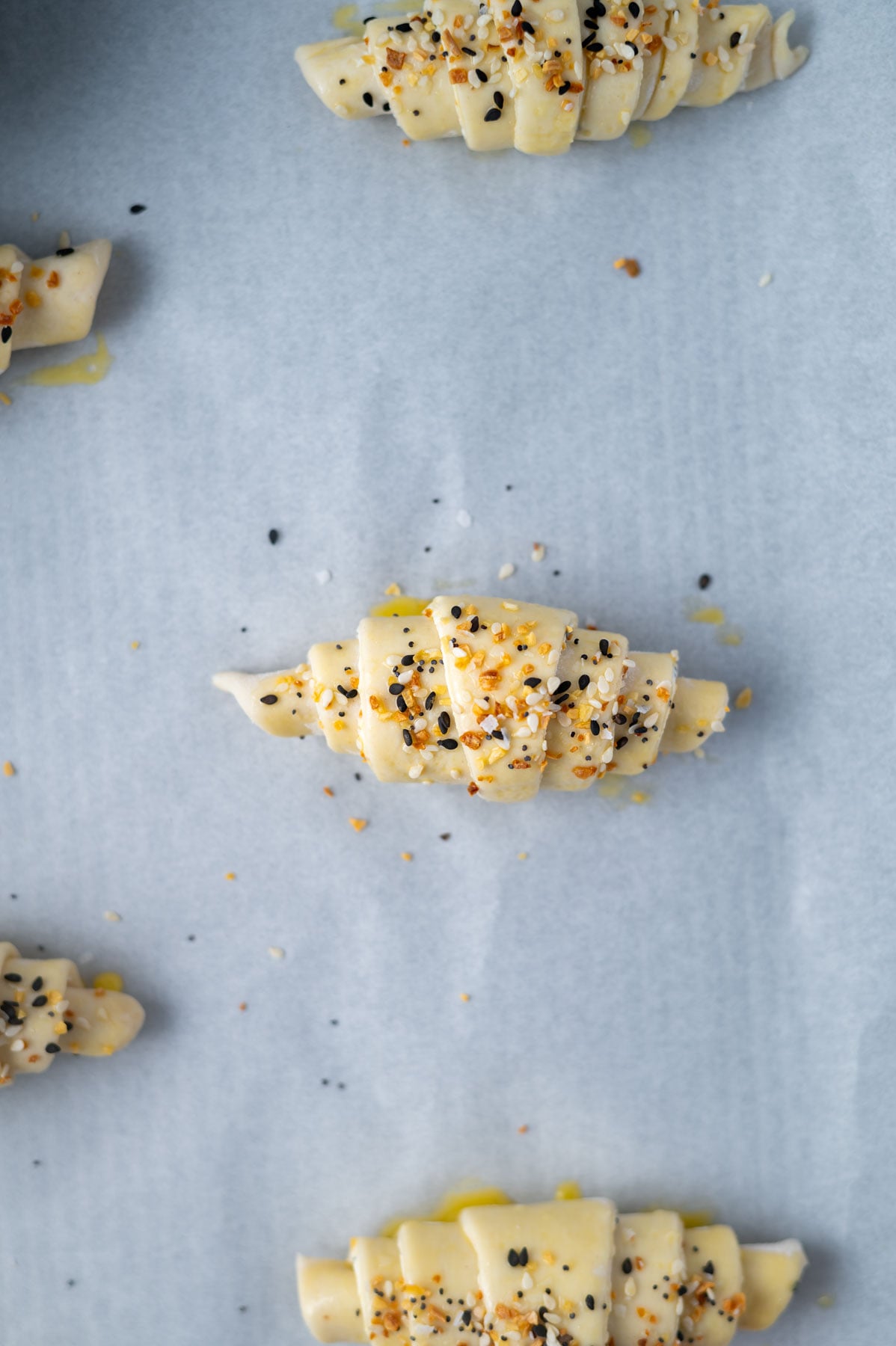 everything seasoning sprinkled on top of unbaked croissants