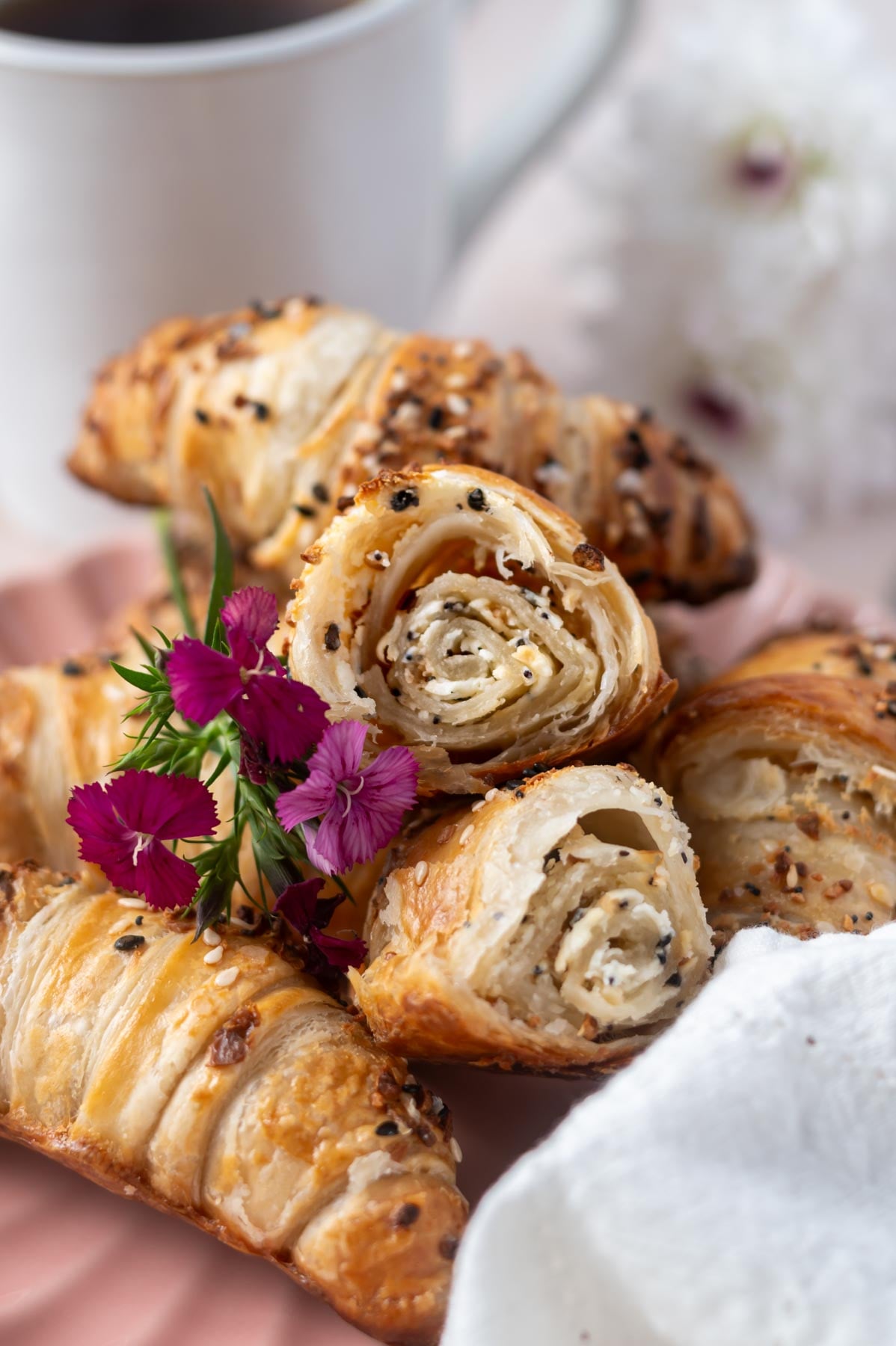 croissants on a plate with one broken in half to show layered center