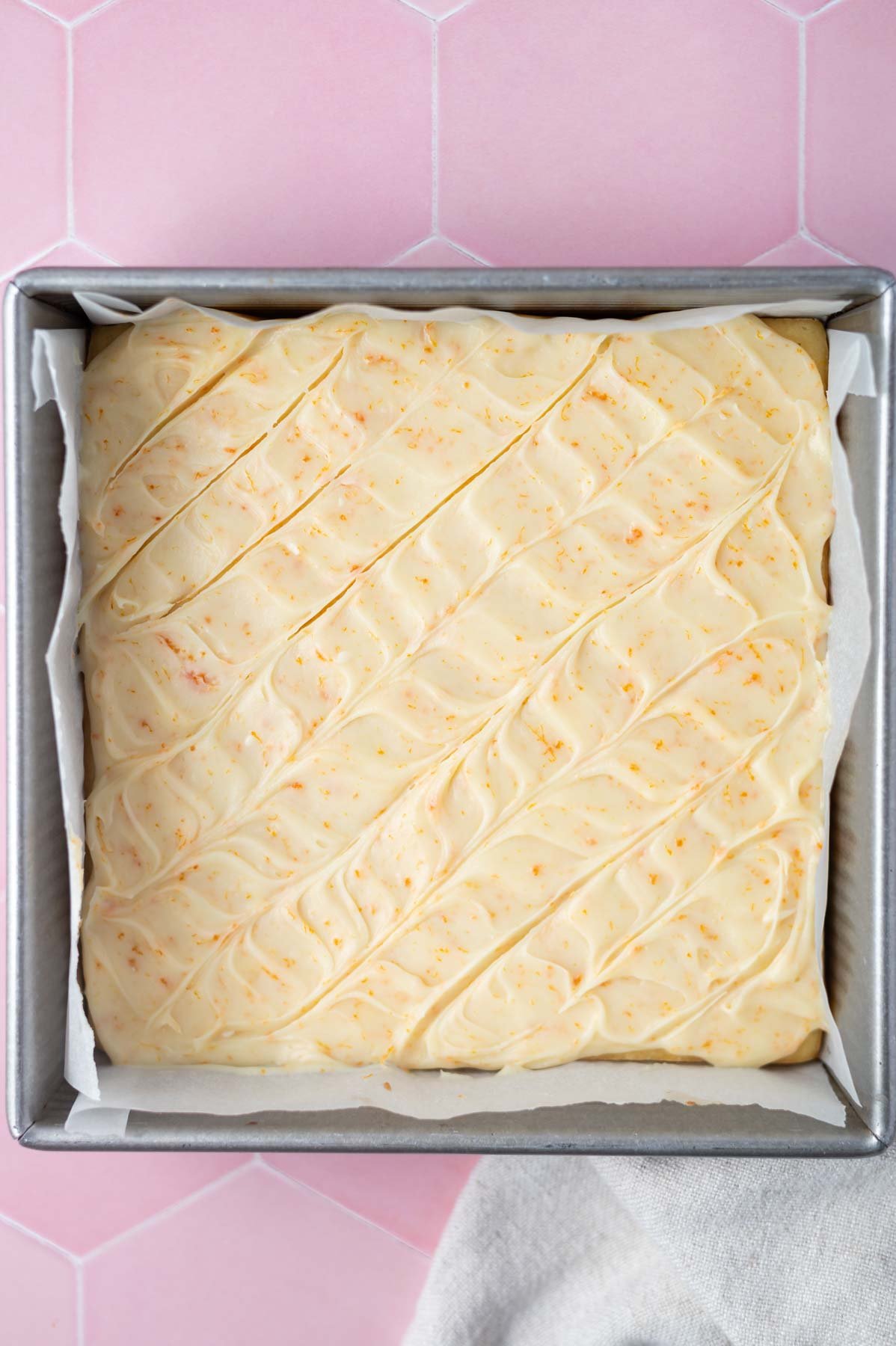 creamy orange white chocolate ganache in a pattern on top of baked dessert bars