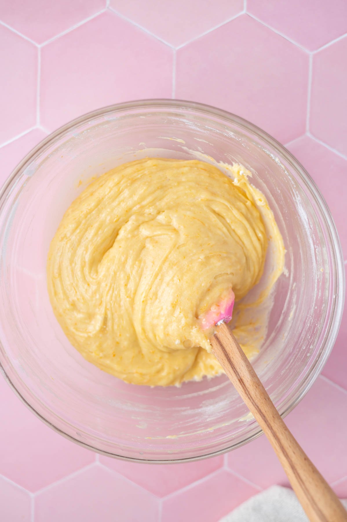 orange bars batter in a glass bowl with a spatula