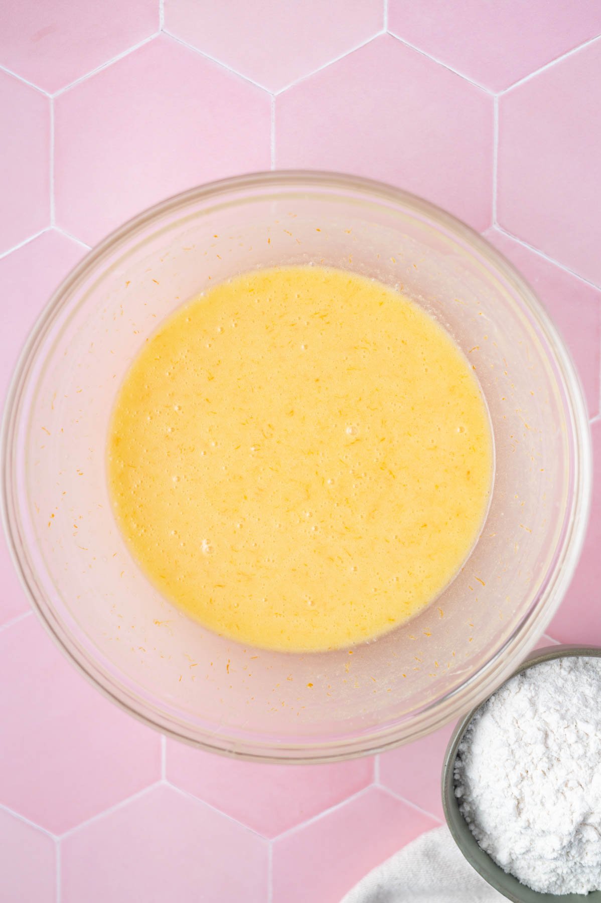 orange zest and juice mixed into dessert bar batter in a glass bowl