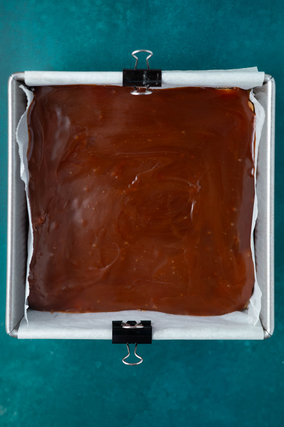 caramel layer poured into an 8x8 pan
