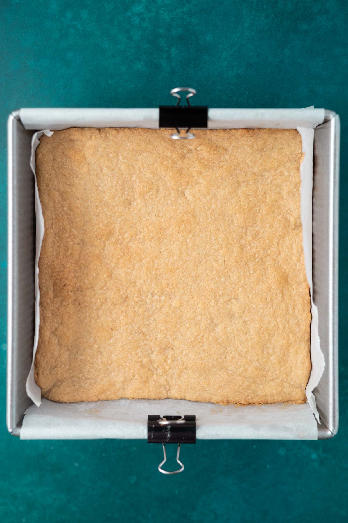 baked shortbread in a parchment lined pan