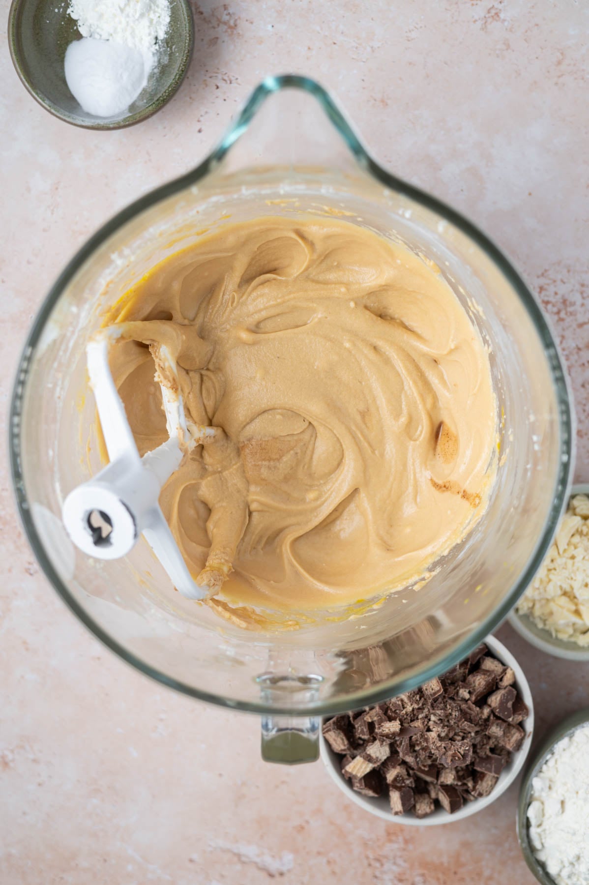 eggs and vanilla added to cookie dough in a mixing bowl