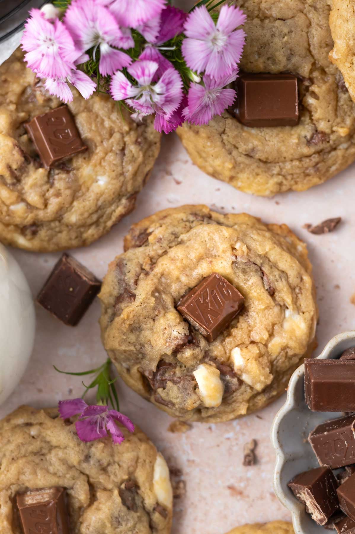 pile Kit Kat cookies with extra candy bar pieces and fresh flowers