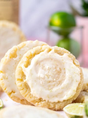 margarita cookies leaning on each other with glaze and sea salt on top