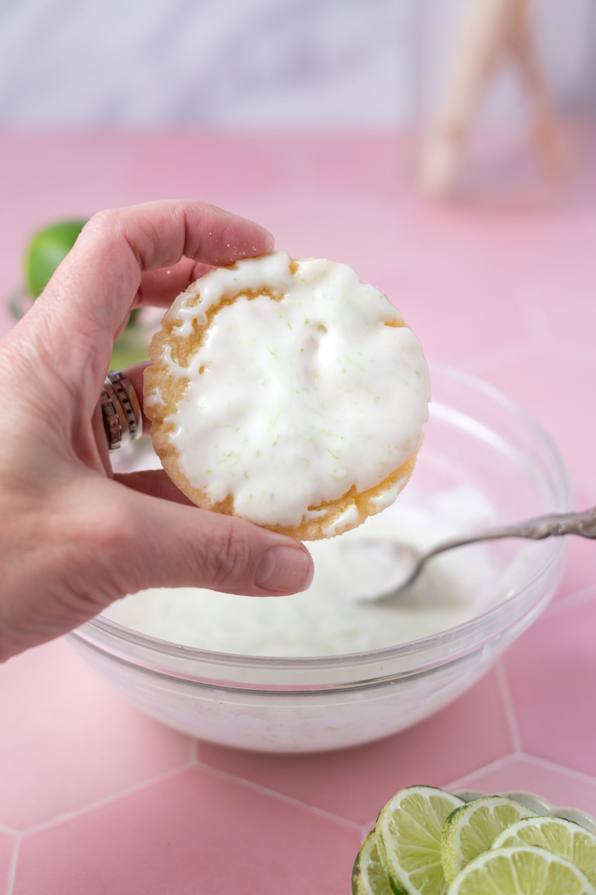 hand holding a cookie that has been dipped in icing