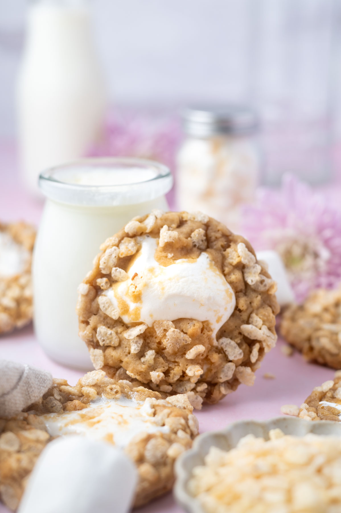 cookie leaning agains a glass of milk