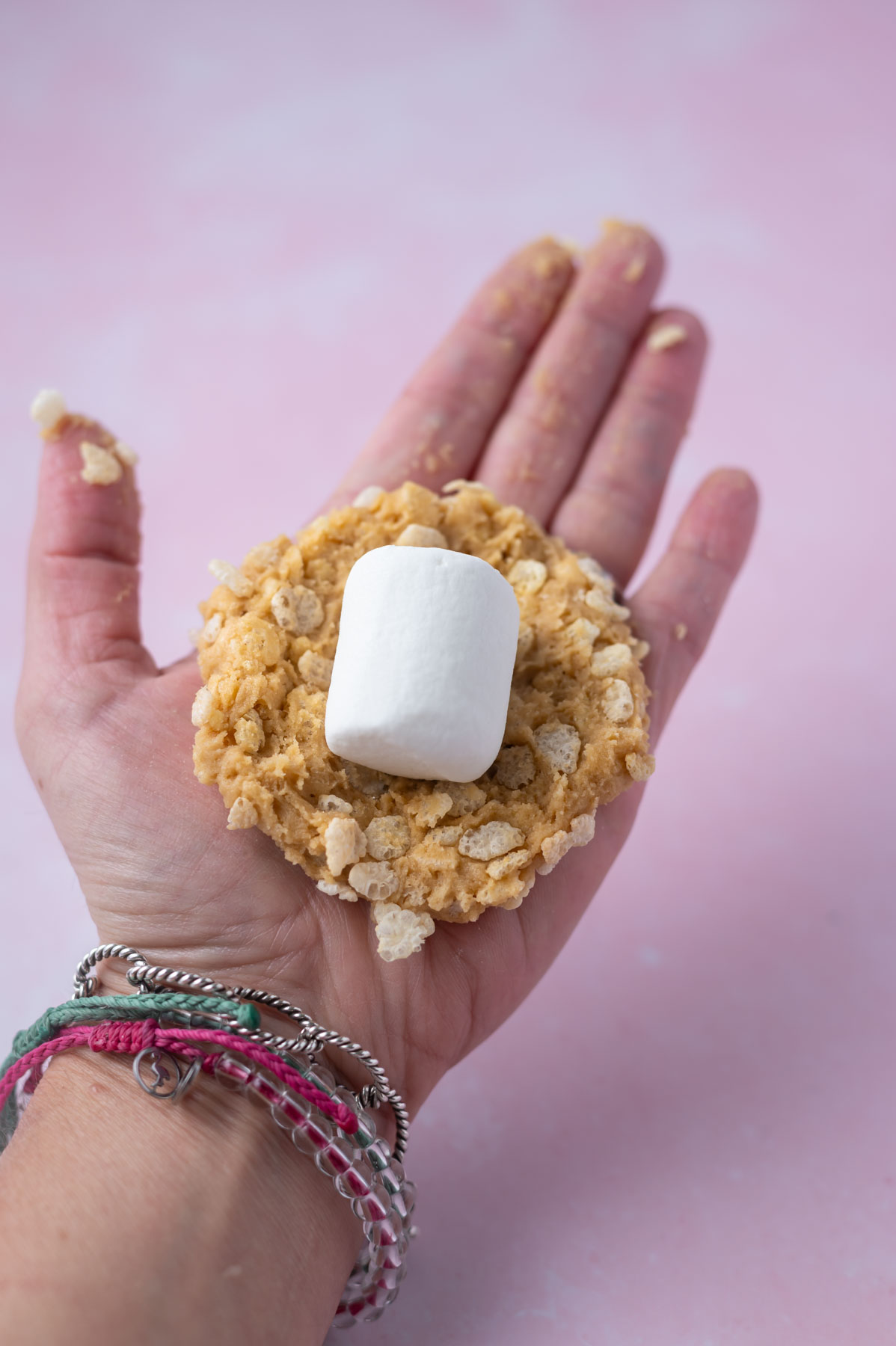 large marshmallow laid in a flattened cookie dough ball
