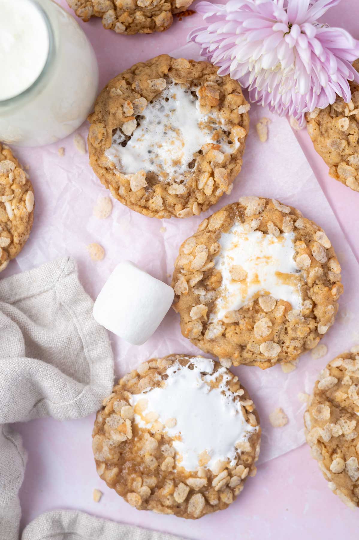 cookies on a pink background with three different marshmallow middles