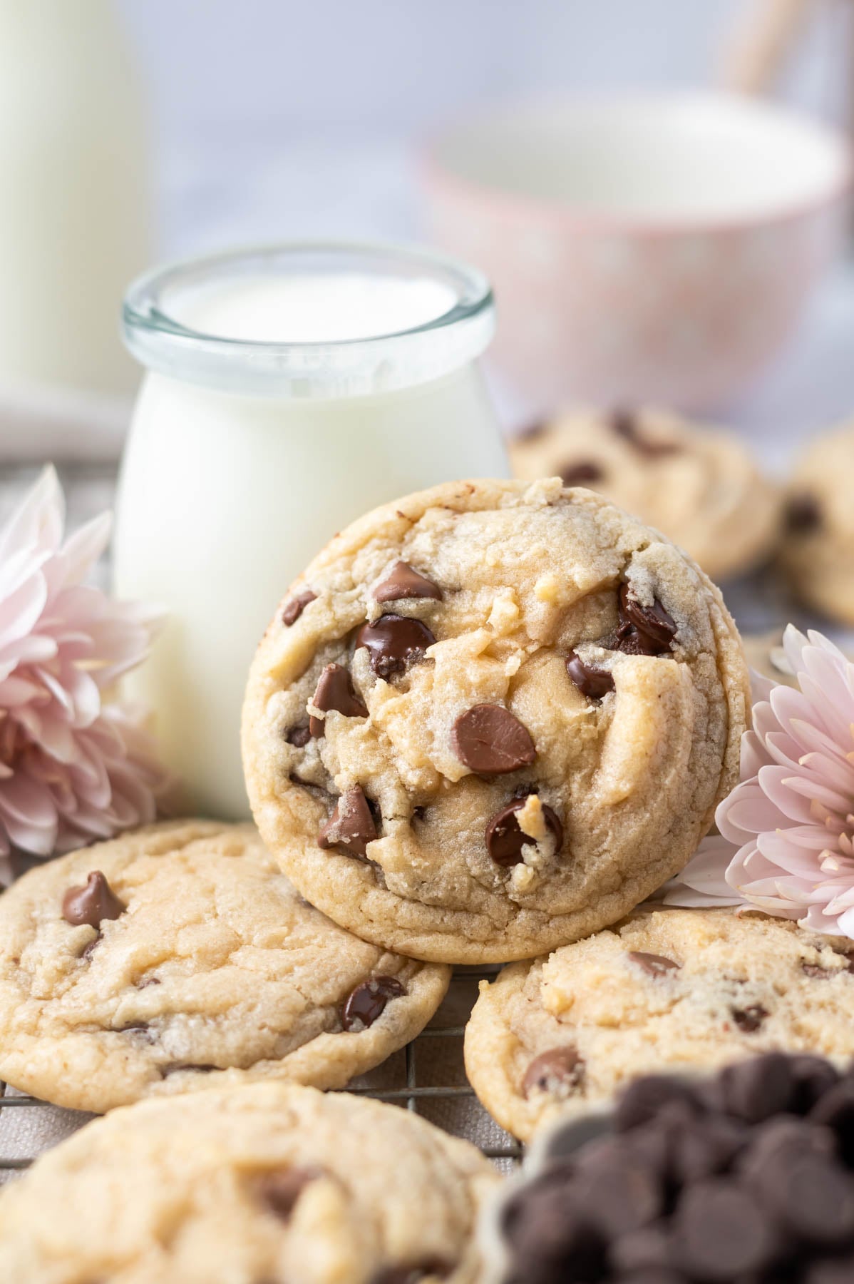 cookie leaning up against a glass of milk