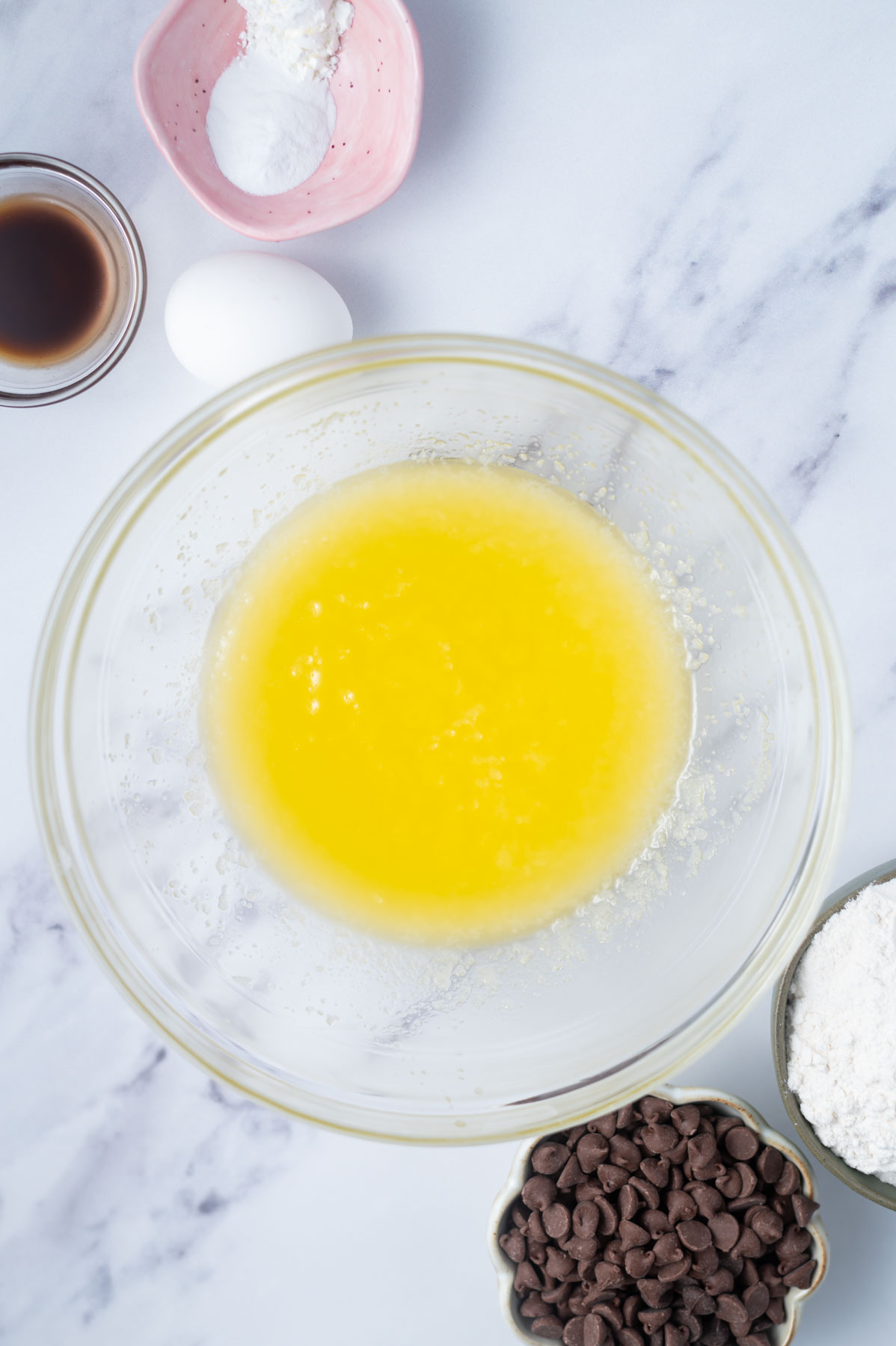melted butter and white sugar mixed together in a glass bowl