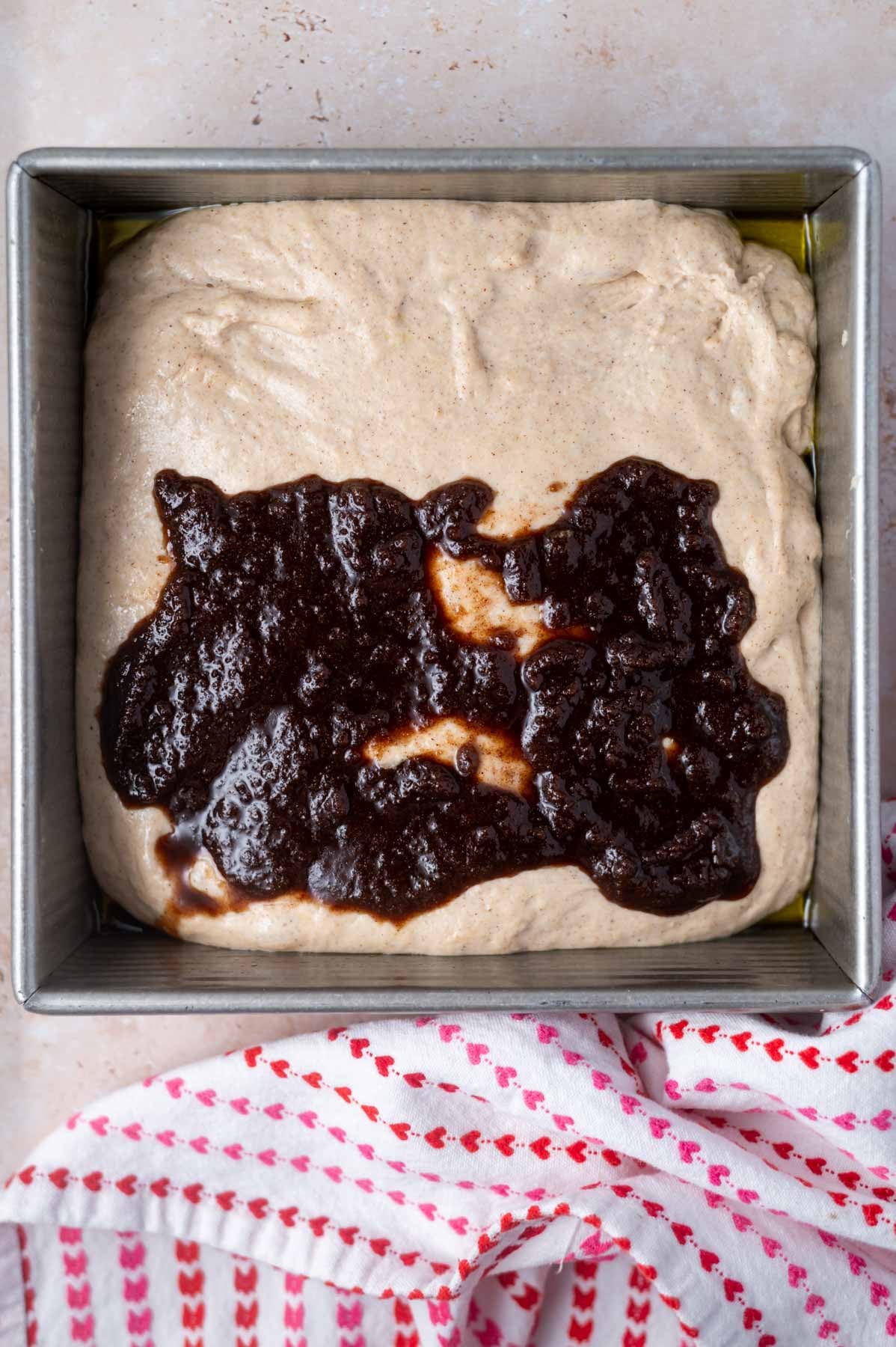 cinnamon roll filling spread over dough