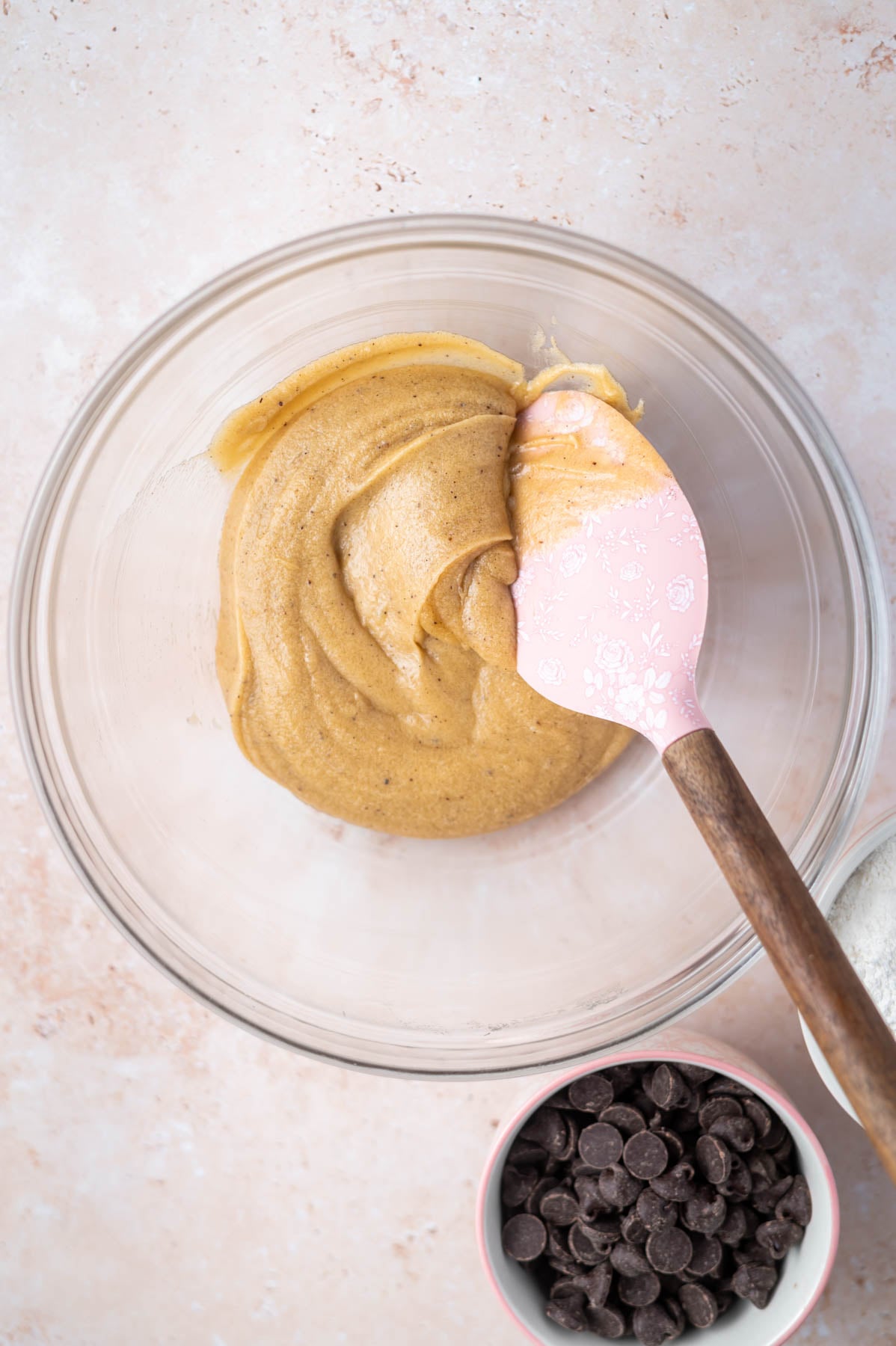 cookie dough in a bowl with a spatula before the flour is added