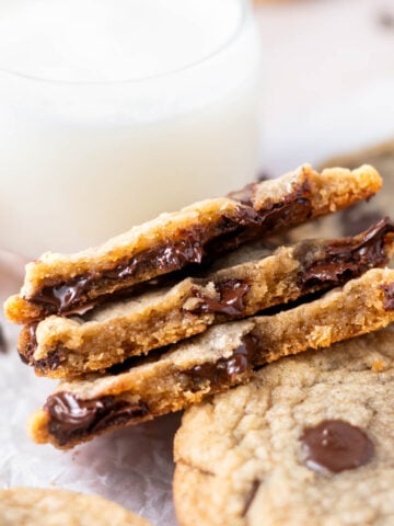 crispy chocolate chip cookies broken in half showing melty chips and chewy inside texture