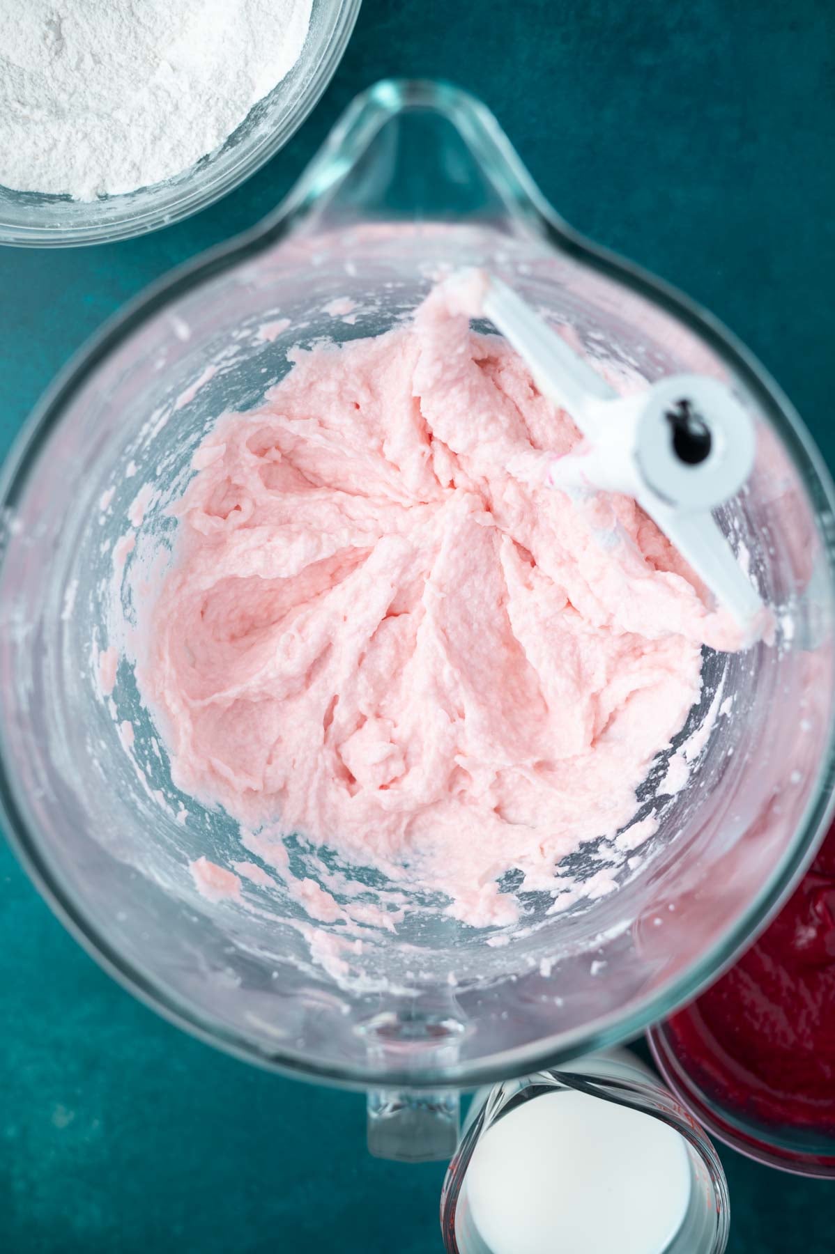 butter, sugar, pink food coloring and first half of egg whites mixed together in a mixing bowl