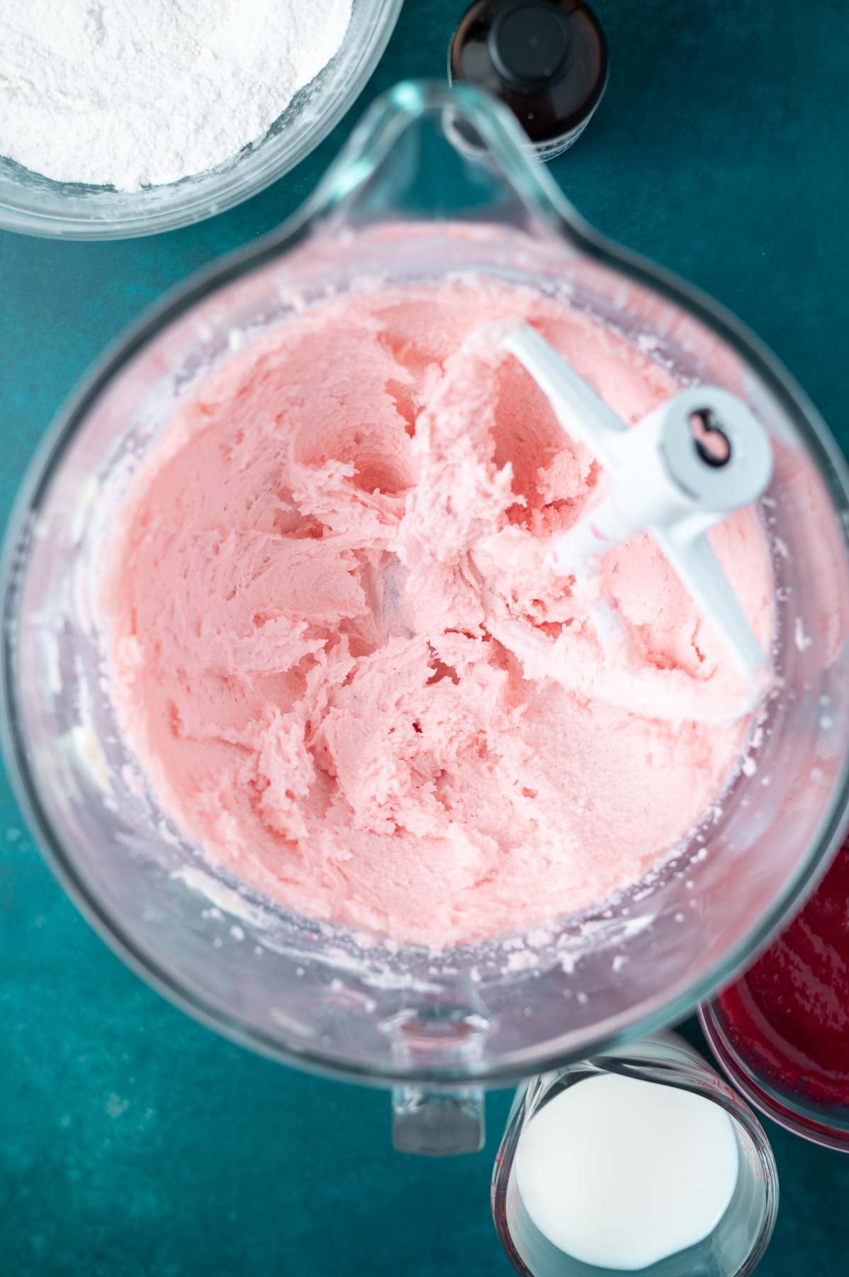 butter, sugar and pink food coloring beaten together in a mixing bowl