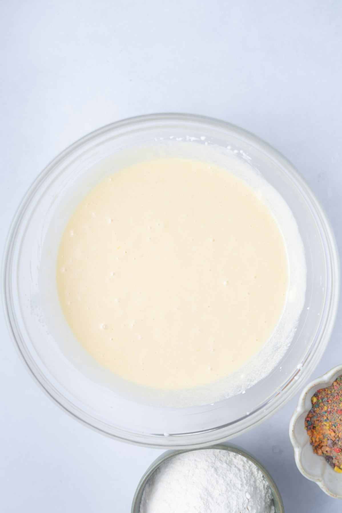 cake batter in a bowl after sour cream and baking soda have been added