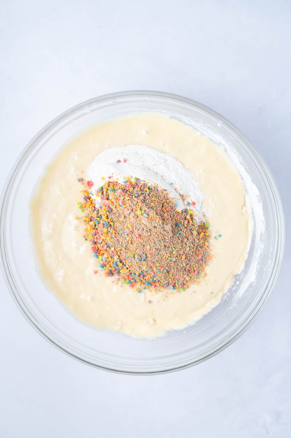 remaining flour and crushed cereal added to cake batter in a bowl