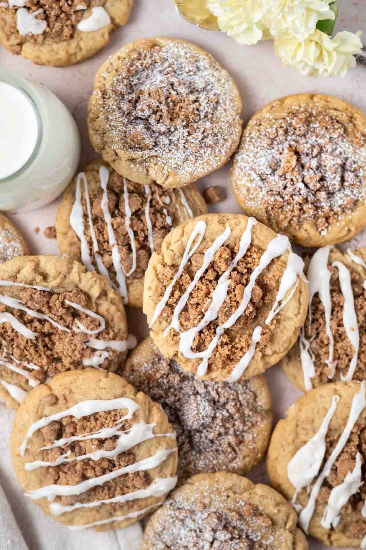 overhead look at coffee cake cookies on parchment paper with a glass of milk