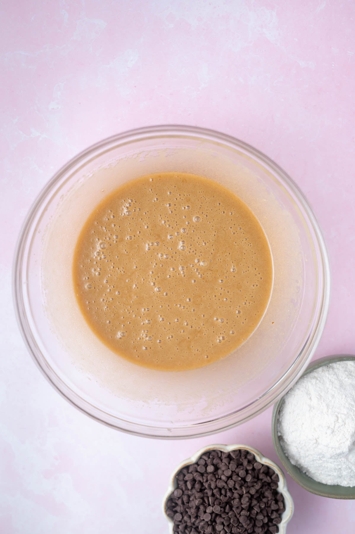 baking soda whisked into cookie dough in a glass bowl