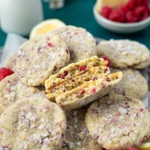 plate of lemon raspberry cookies with a few broken showing the soft inside texture