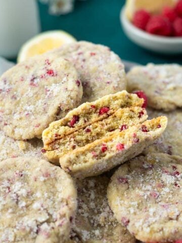 plate of lemon raspberry cookies with a few broken showing the soft inside texture