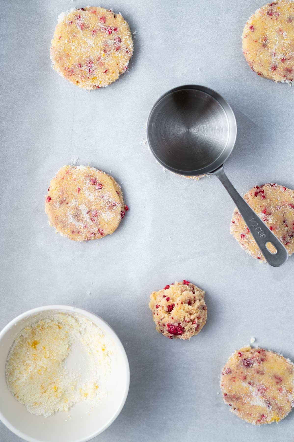 cookie dough with lemon sugar on a parchment lined baking pan
