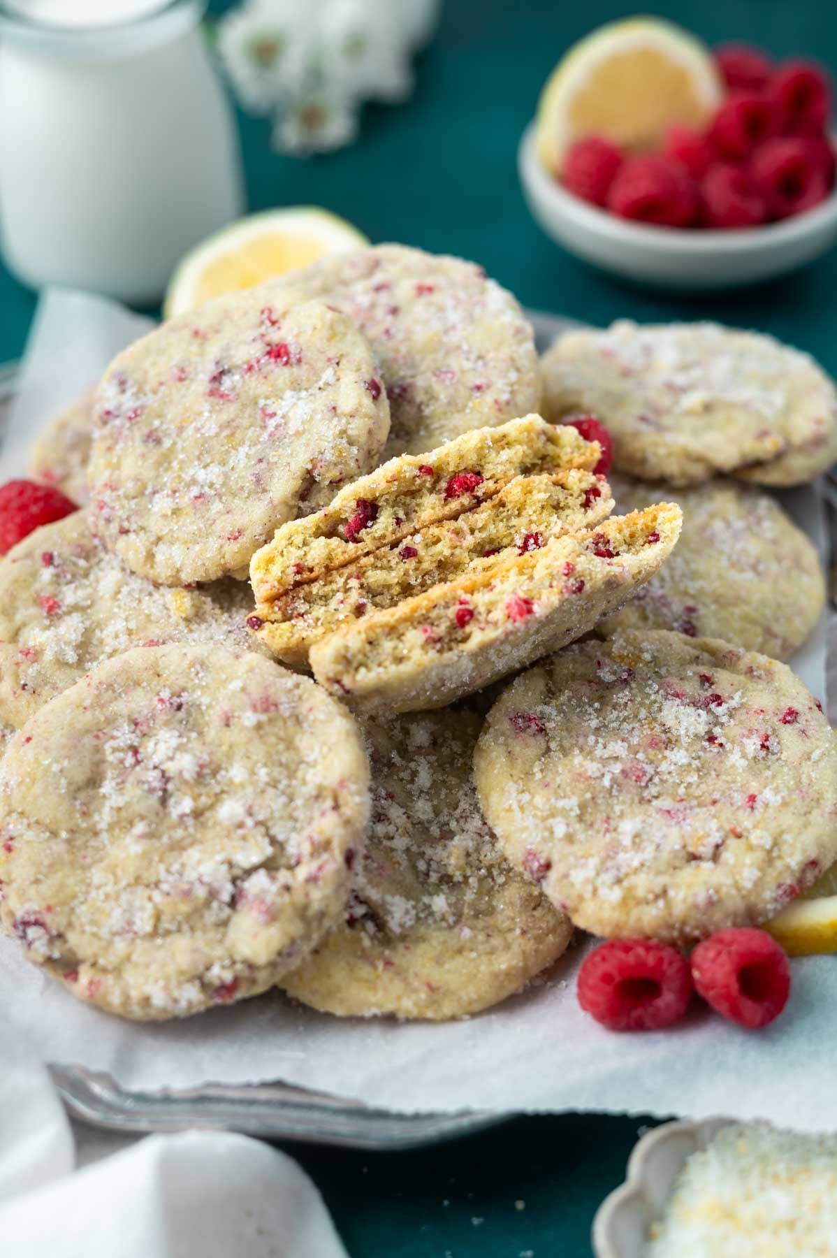 plate of lemon raspberry cookies with a few broken showing the soft inside texture