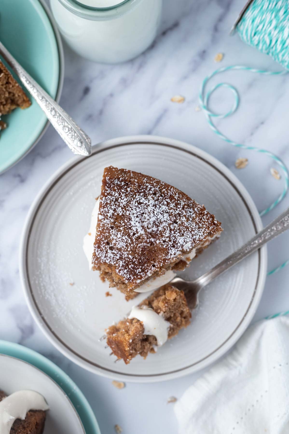 overhead look at a slice of cake on a plate with a bite on a fork