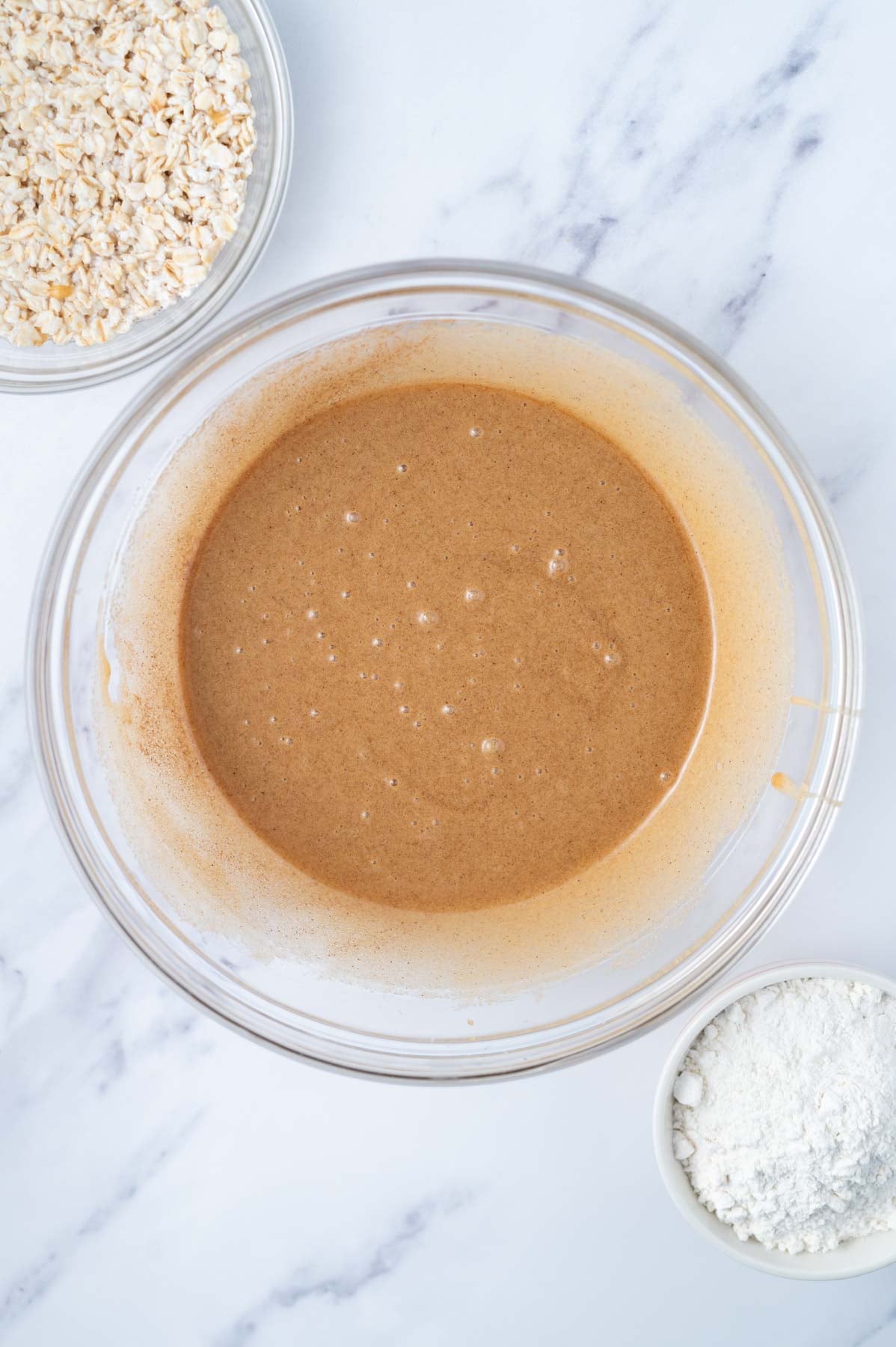 baking soda and cinnamon mixed into cake batter in a bowl