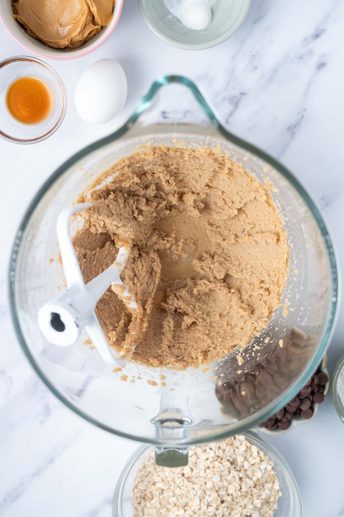 butter and sugars creamed together in a glass mixing bowl