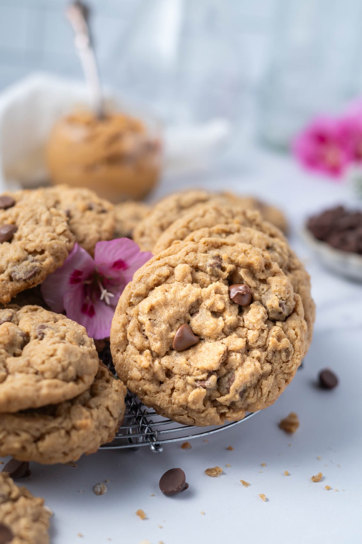 cookies on a round cooling rack with fresh pink flowers