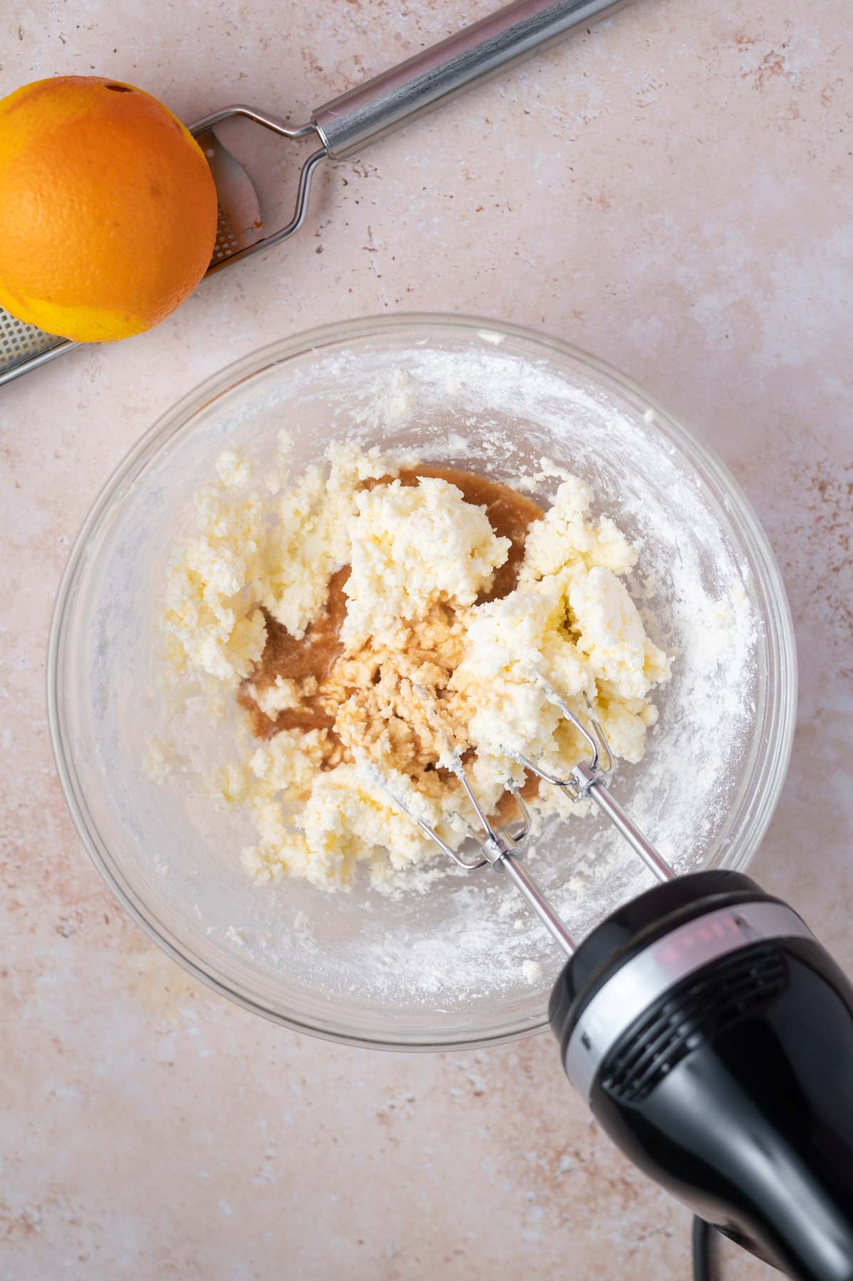 vanilla and milk added to buttercream in a bowl