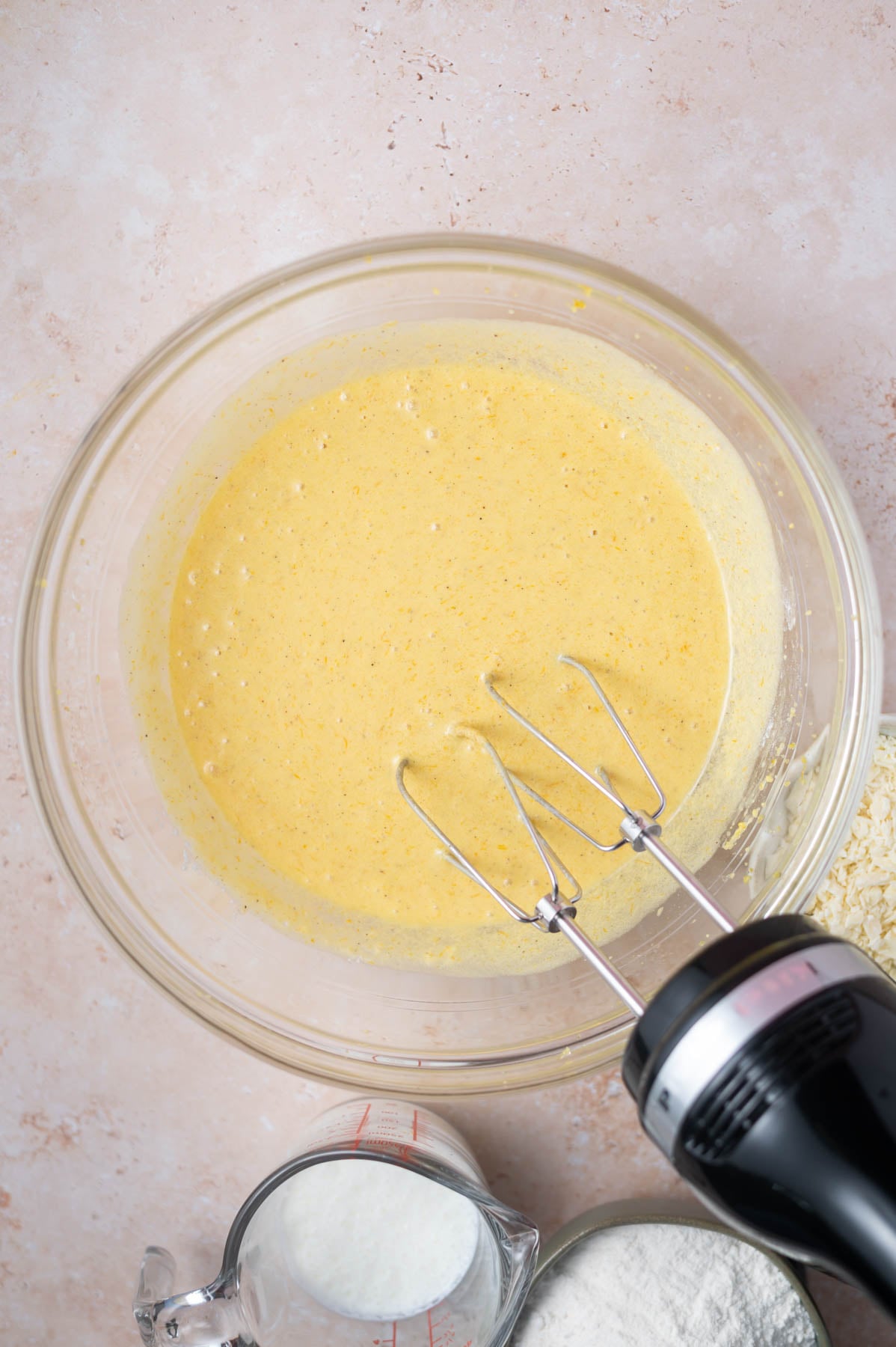 sour cream and baking powder mixed into batter with a hand mixer
