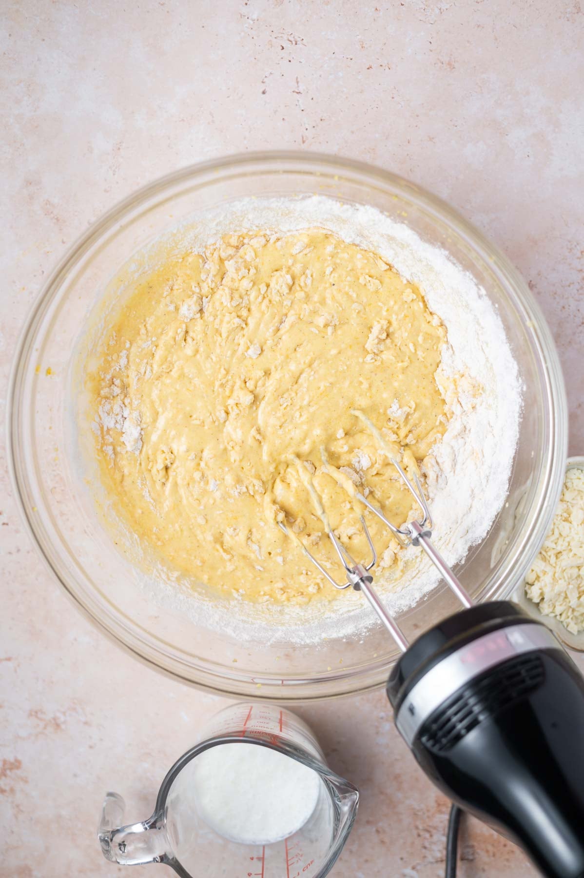 streaks of flour showing in cake batter in a bowl