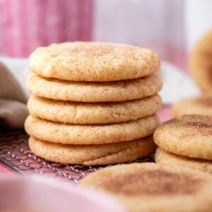 stack of thick, soft snickerdoodle cookies on a cooling rack