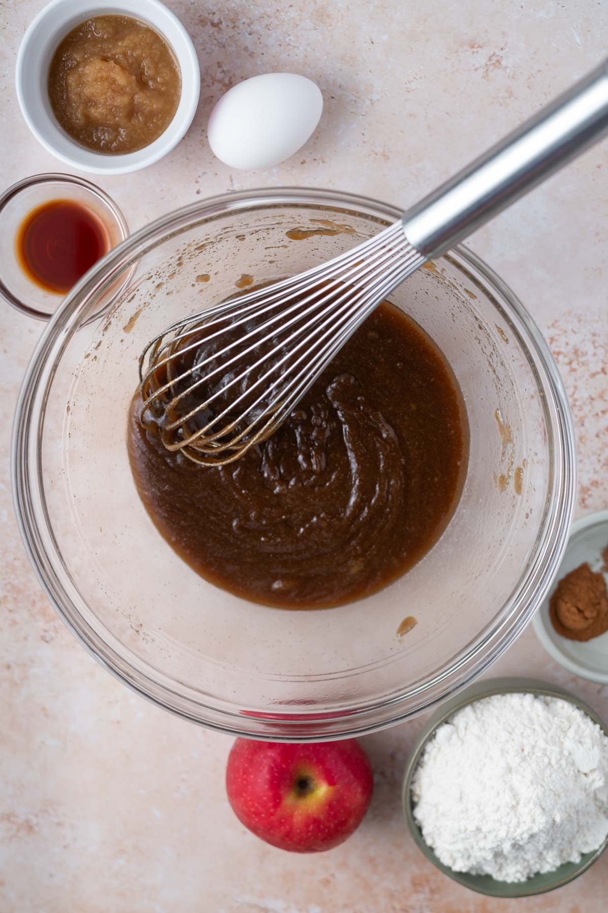 butter and sugars whisked together in a glass bowl