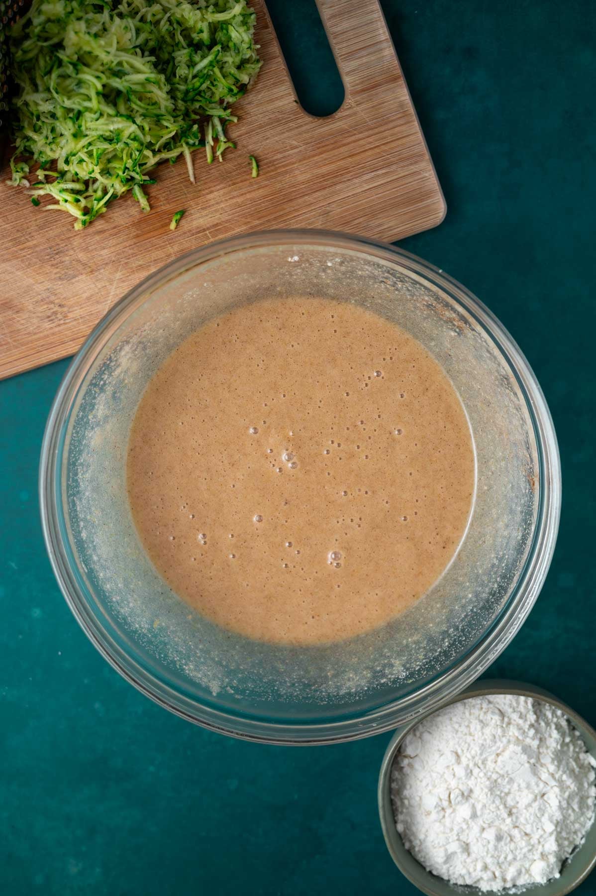 cake batter in a bowl before flour and grated zucchini are added