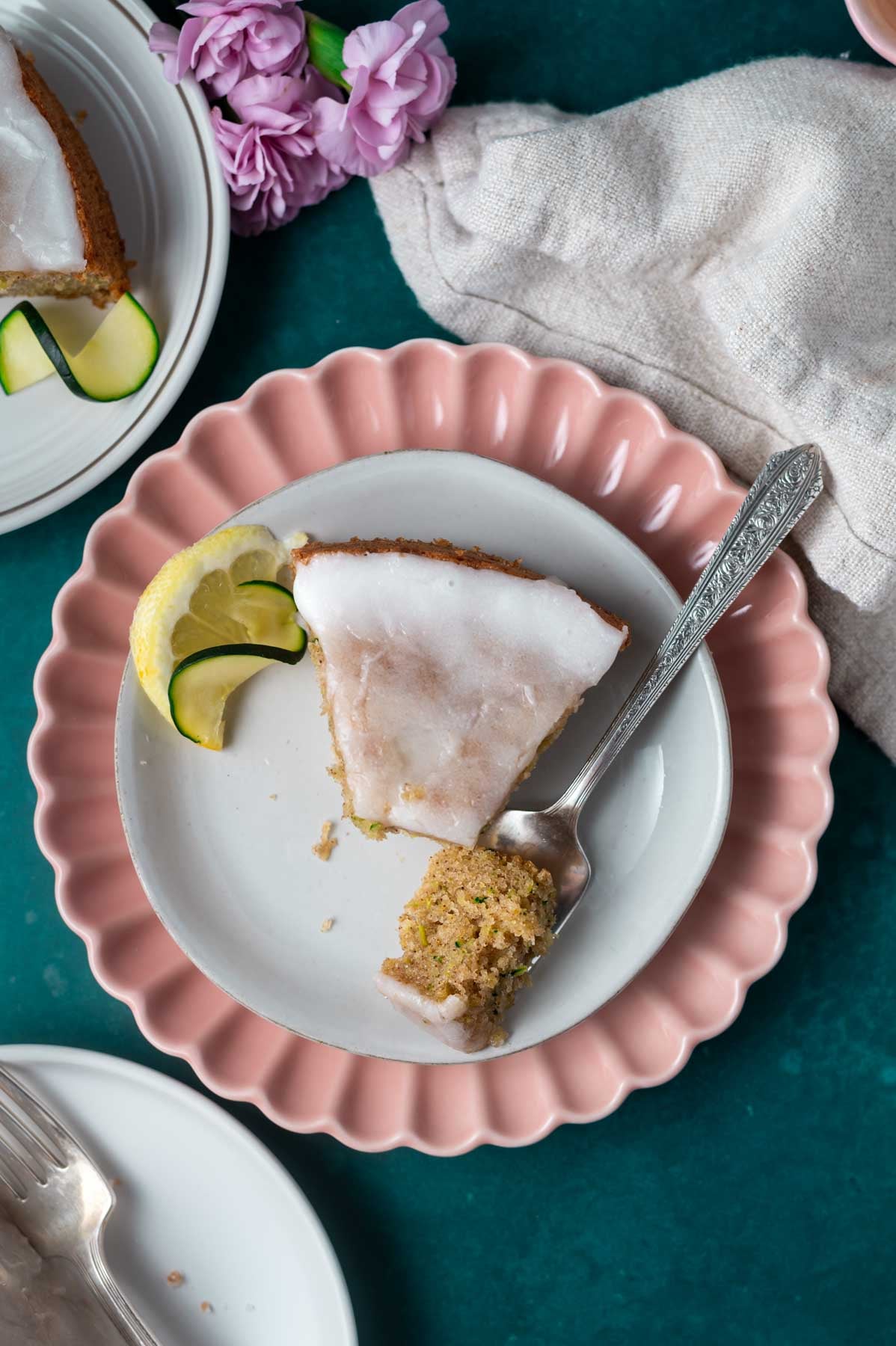 slice of cake on a plate with a bite on a fork