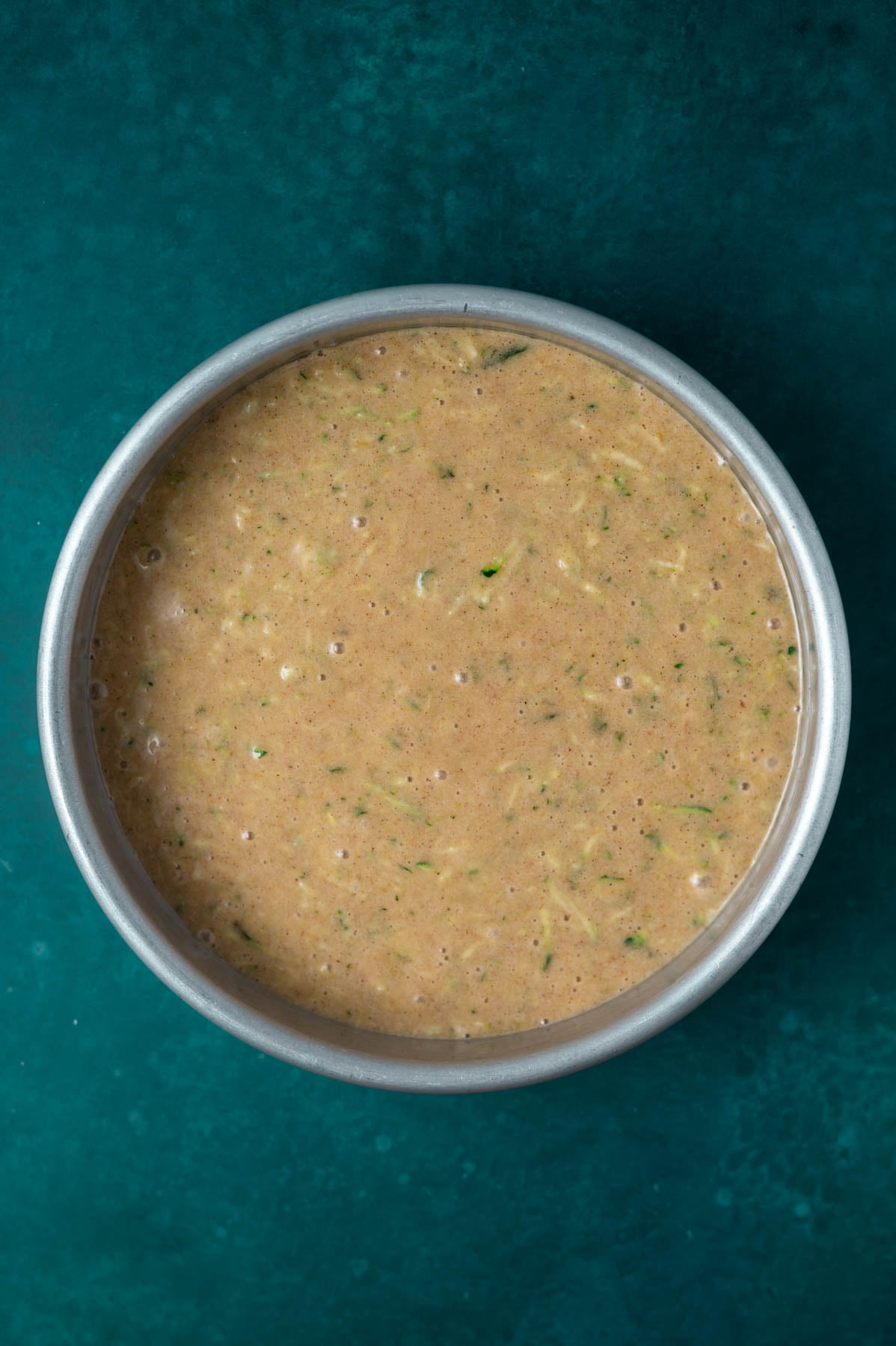 cake batter in a round baking pan