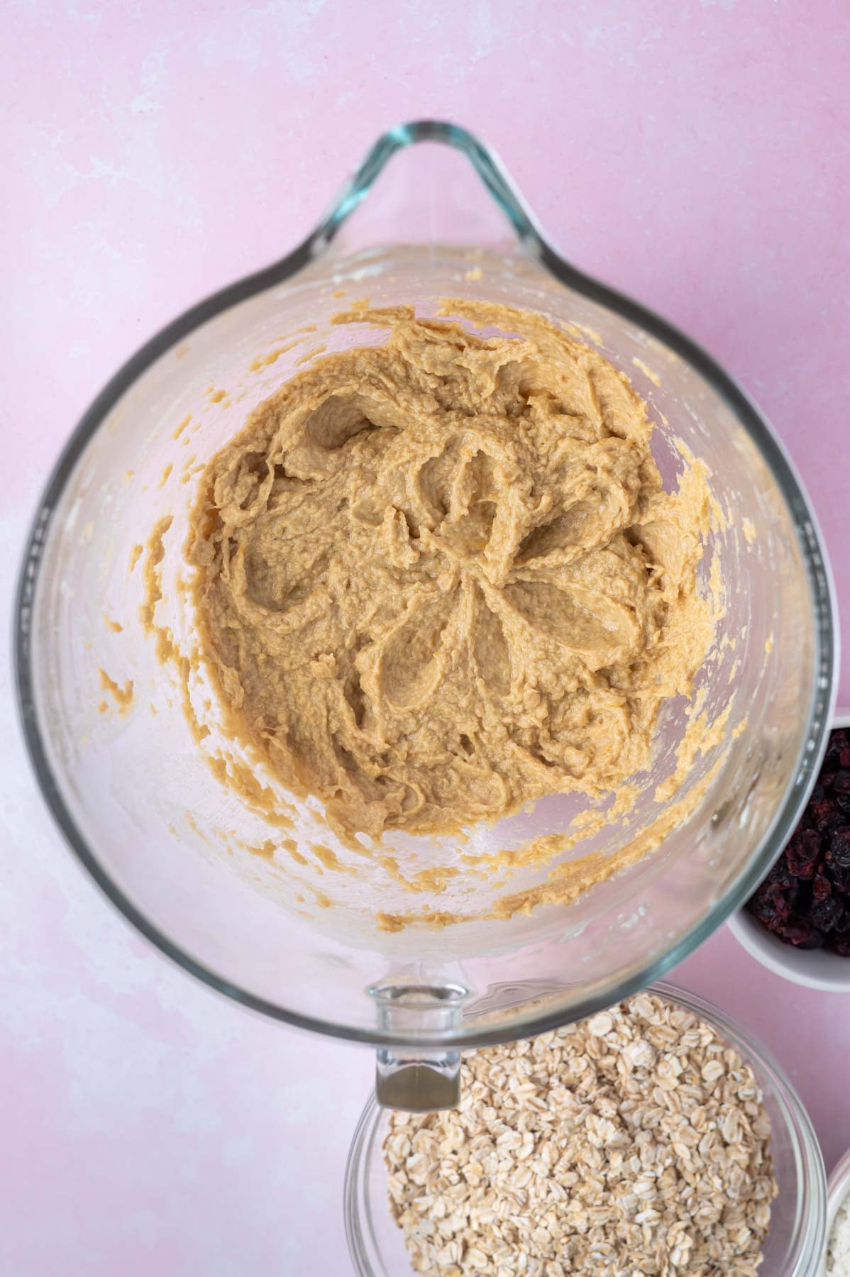 eggs and vanilla added to cookie dough in a mixing bowl