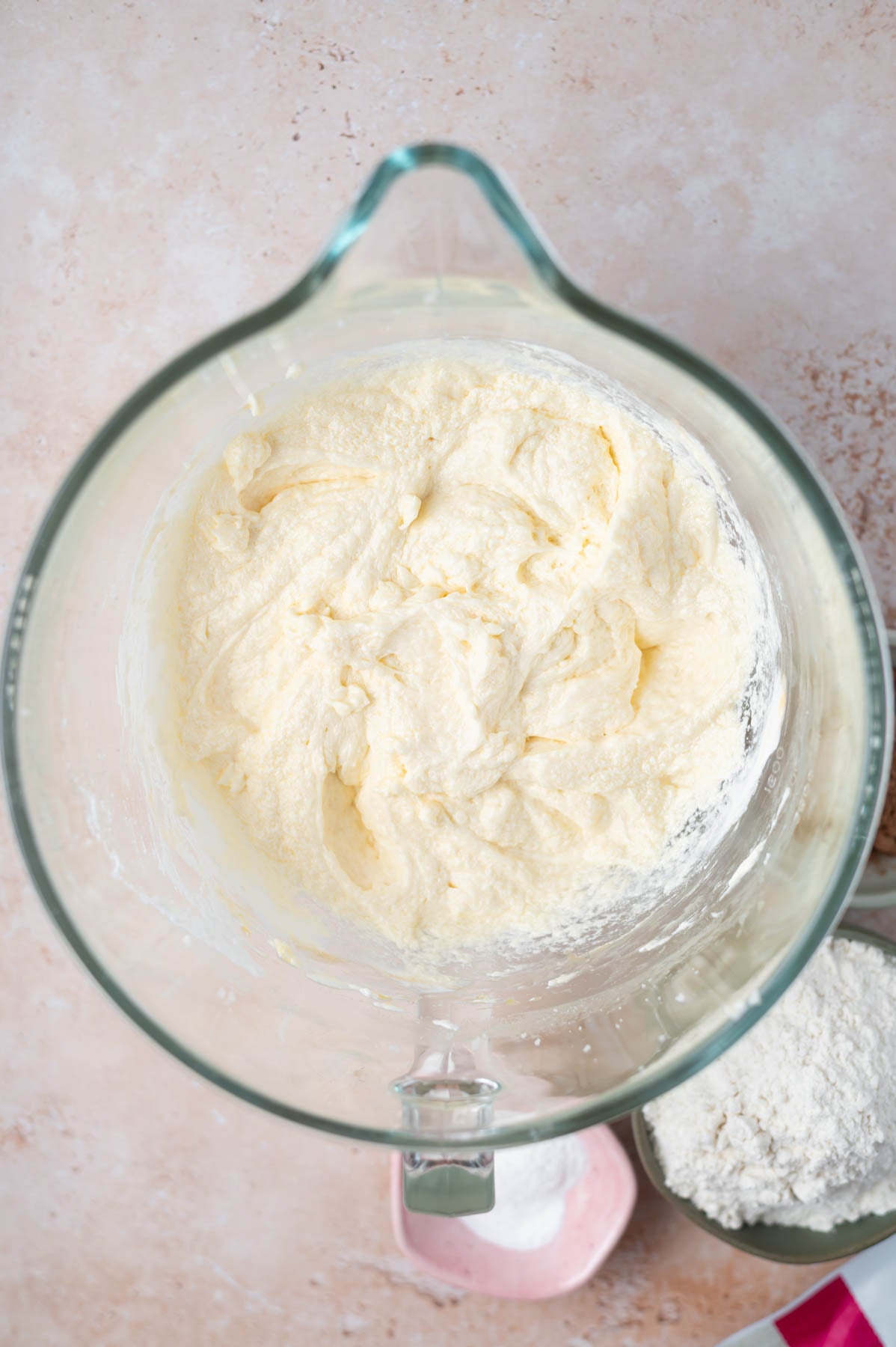 cake batter in a mixing bowl after vanilla and sour cream have been added