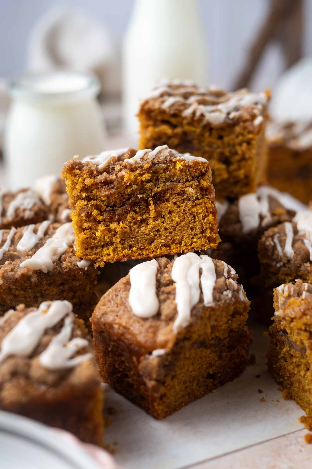 pile of cake slices with milk jars in the background