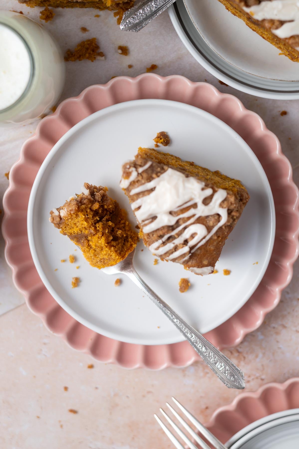 slice of cake on a plate with a bite on a fork