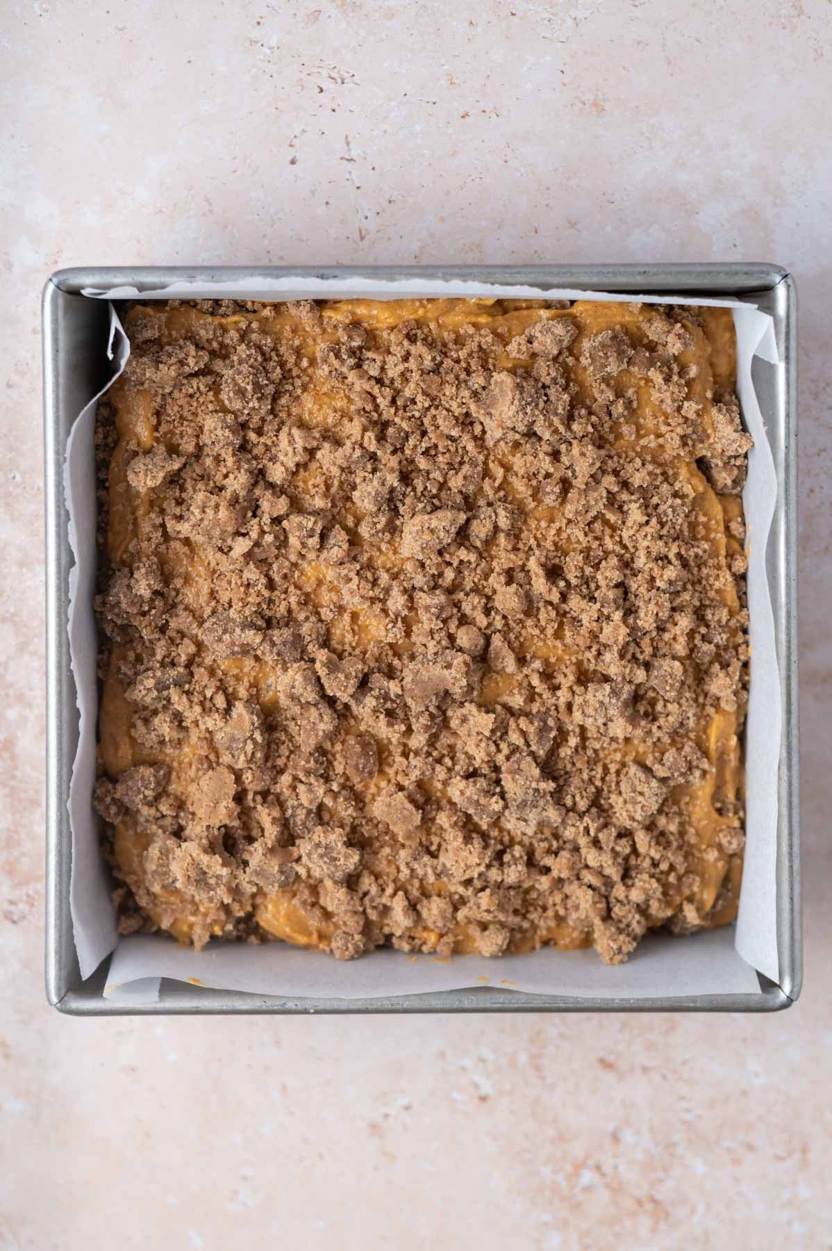 streusel filling over batter in a baking pan