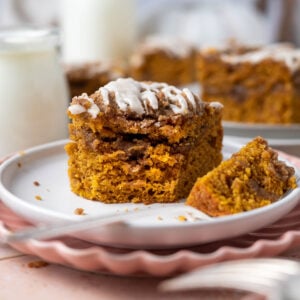 slice of pumpkin coffee cake with streusel on a plate with a bite on a fork