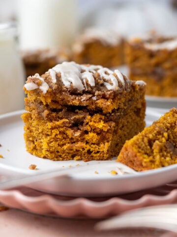 slice of pumpkin coffee cake with streusel on a plate with a bite on a fork