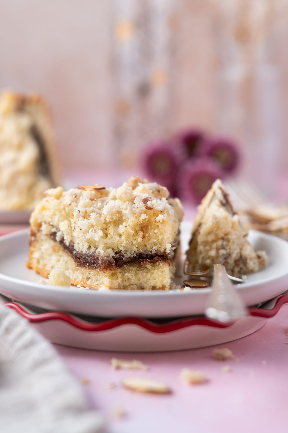 slice of cake on a plate with a bite on a fork